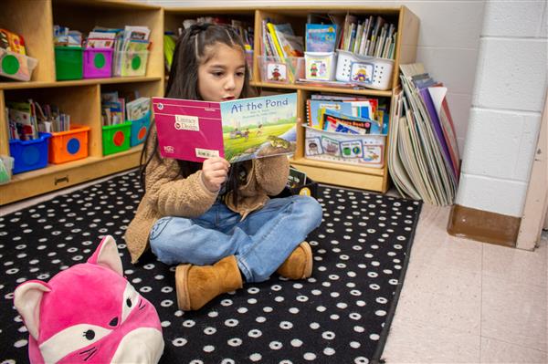 student reading on the floor